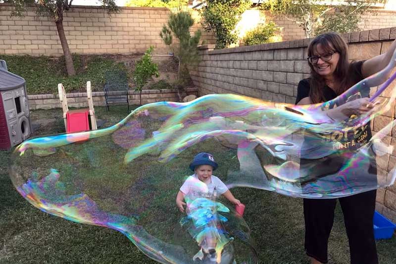 Teacher Mary Makes Huge Bubbles for Child